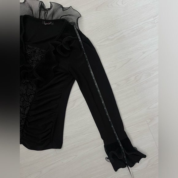 black long-sleeved women's blouse featuring a ruffled neckline and floral lace - Picture 5 of 6